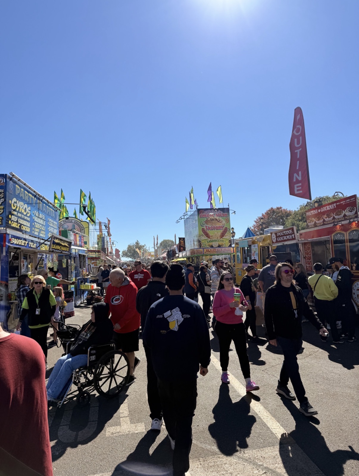 Visitors walking between food vendors at the North Carolina State Fair
